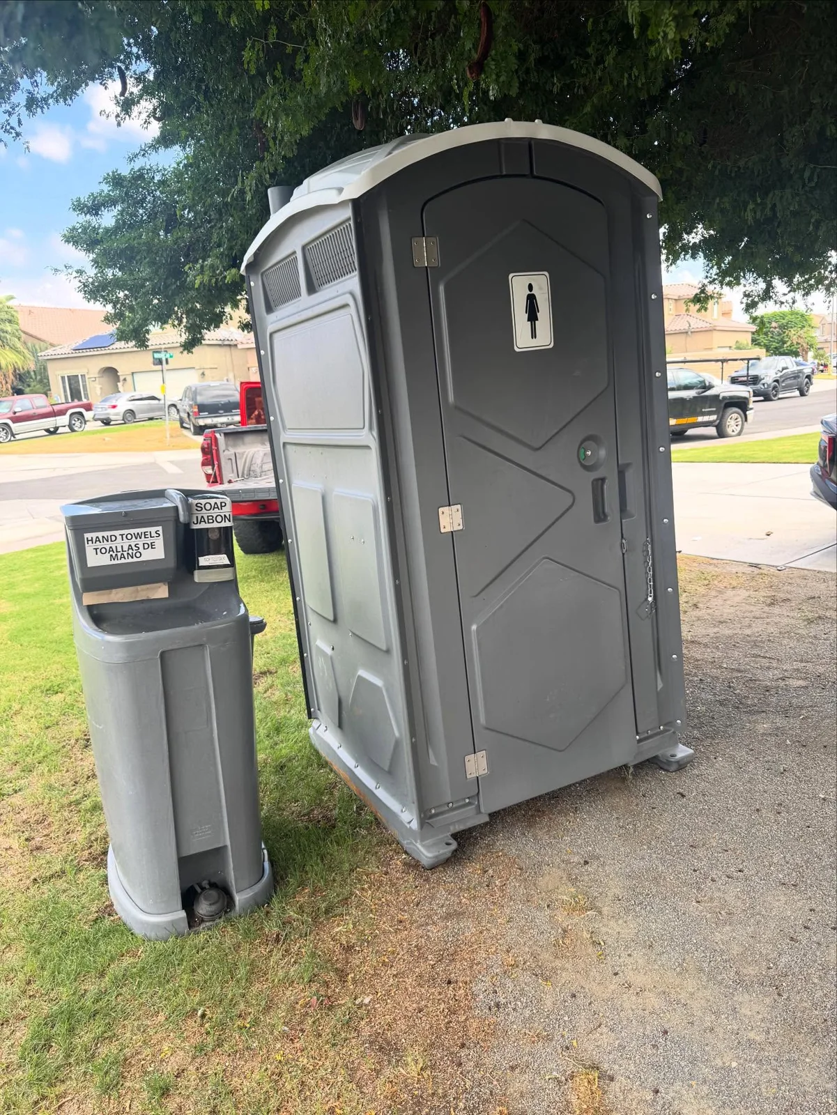 Portable toilet with a separate handwashing station beside it